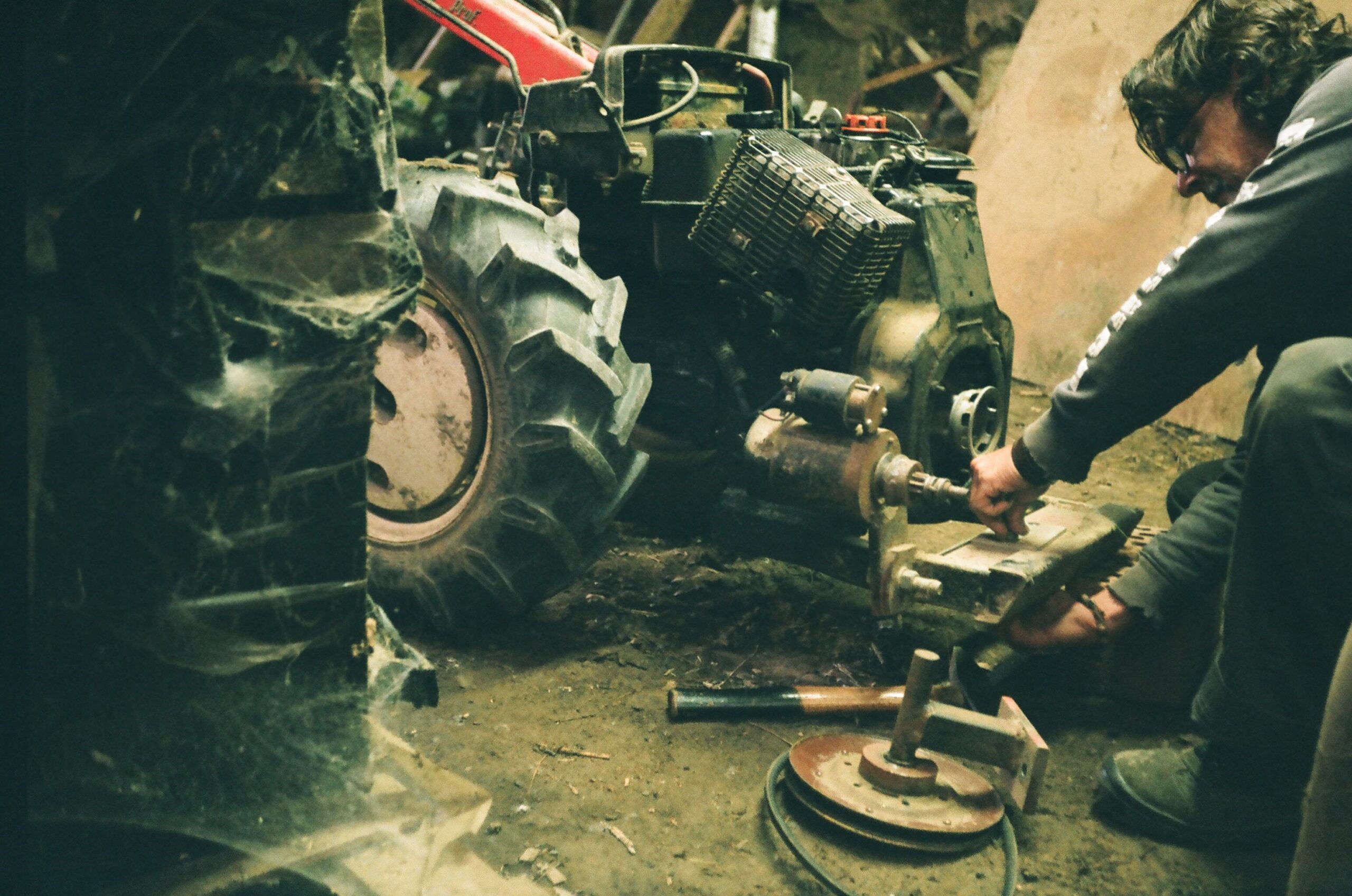 man working on a lawn tractor engine